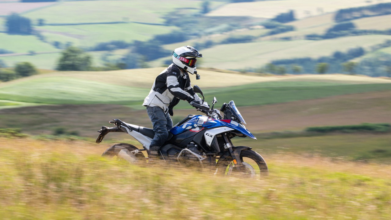 A motorcycle being ridden along a green lane
